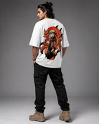 A man shown from the back wearing a white t-shirt with a large graphic of Naruto and his fox companion on the back, paired with black cargo pants and tan boots, against a gray studio background.