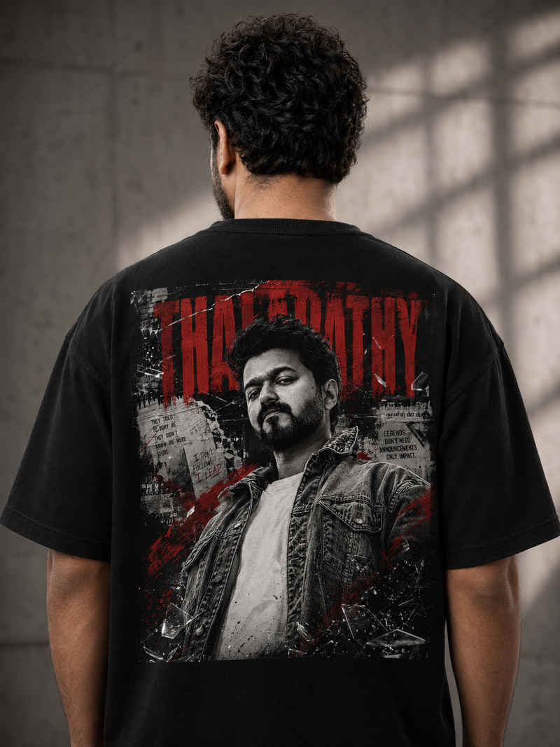 Person wearing a Thalapathy Vijay black t-shirt with a graphic design on the back, featuring a stylized portrait and text.
